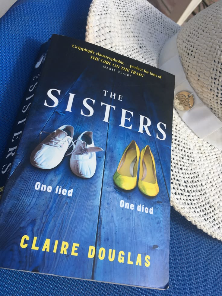 Photograph of The Sisters by Claire Douglas book cover with two pairs of shoes