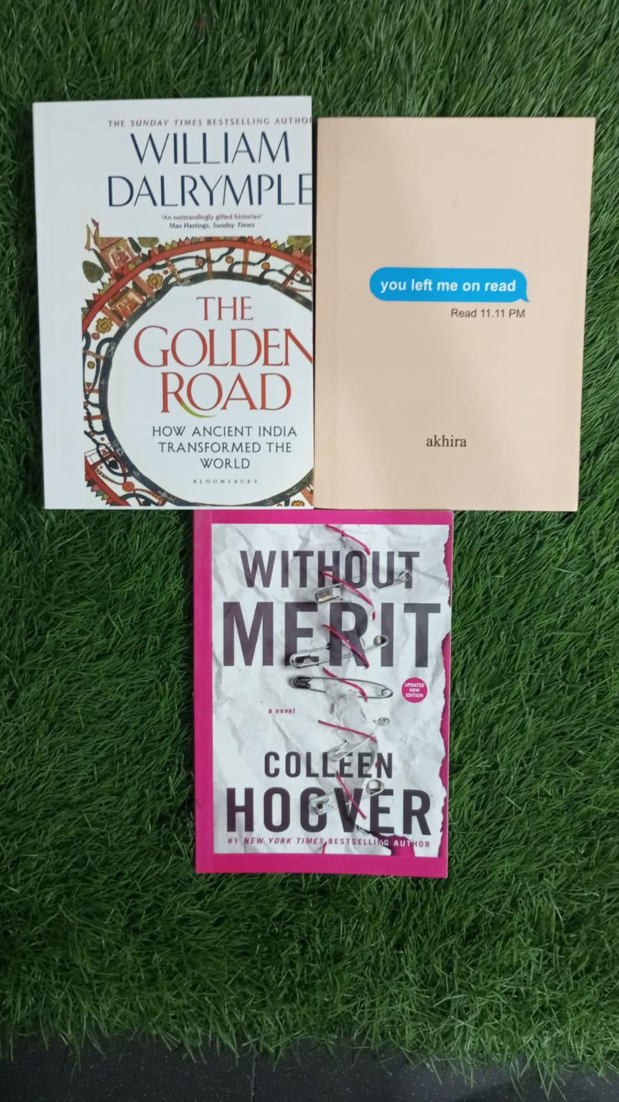 The Golden Road by William Dalrymple, You Left Me on Read by akhira, and Without Merit by Colleen Hoover, photographed together